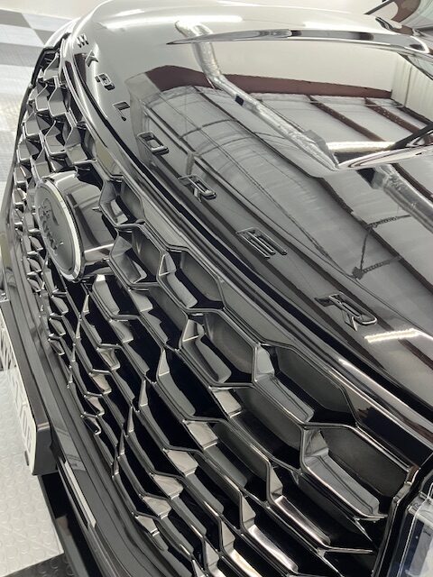 Shiny black grille of a vehicle ceramic coating