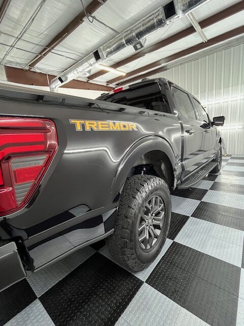 Black truck with Tremor branding ceramic coating